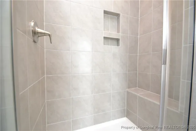 a bathroom with a glass shower door