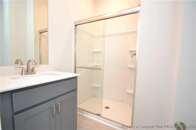 a bathroom with a shower sink and mirror