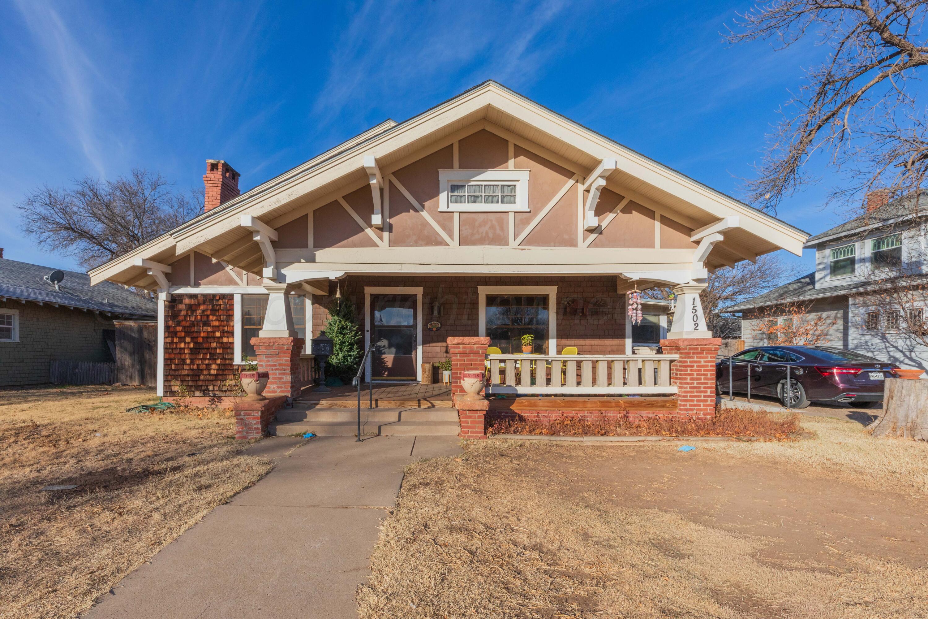 a front view of a house with a yard outdoor seating and garage