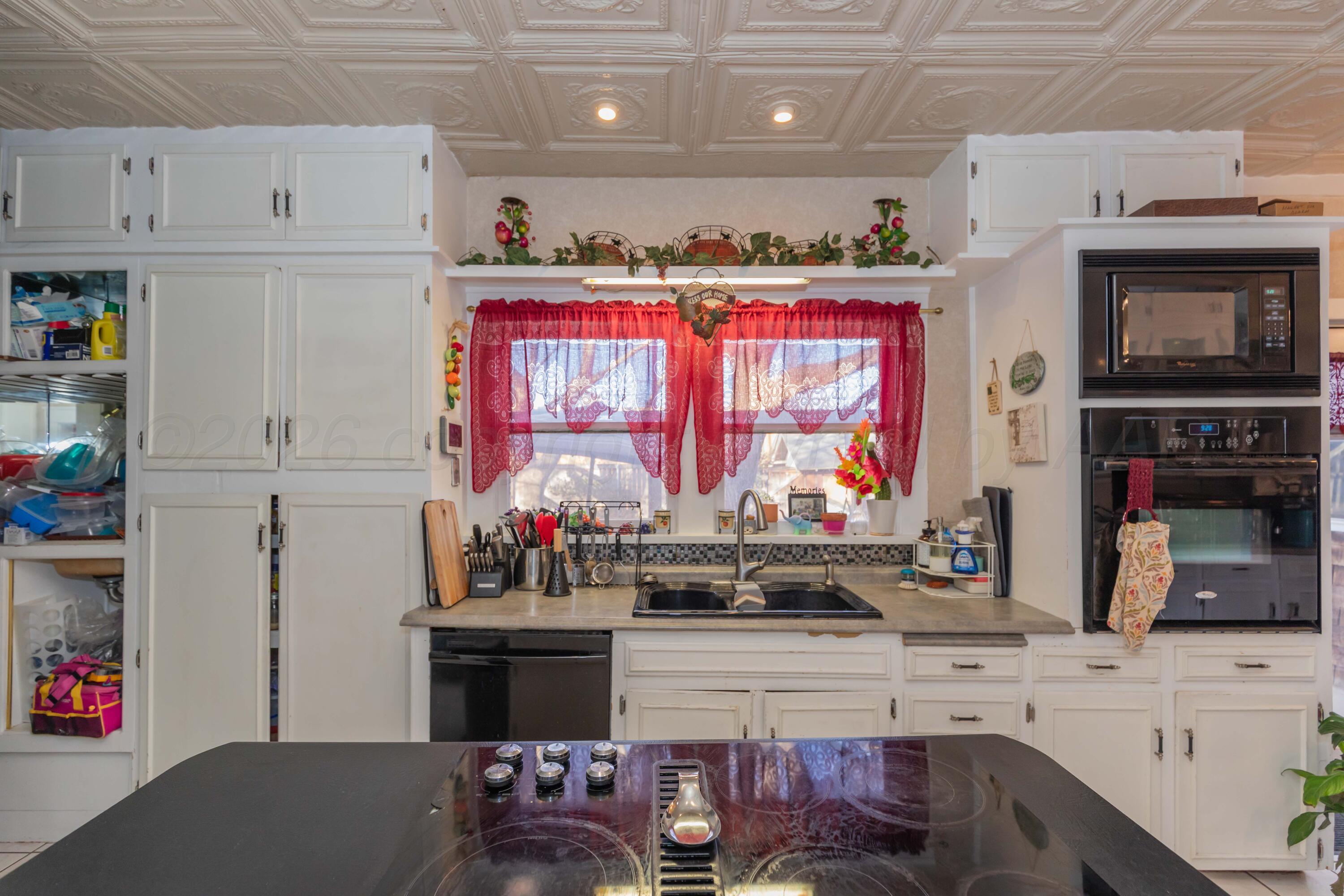 1502 South Monroe Street Amarillo, TX 79101 - Photo 22 of 35 a kitchen with stainless steel appliances kitchen island granite countertop a stove and cabinets
