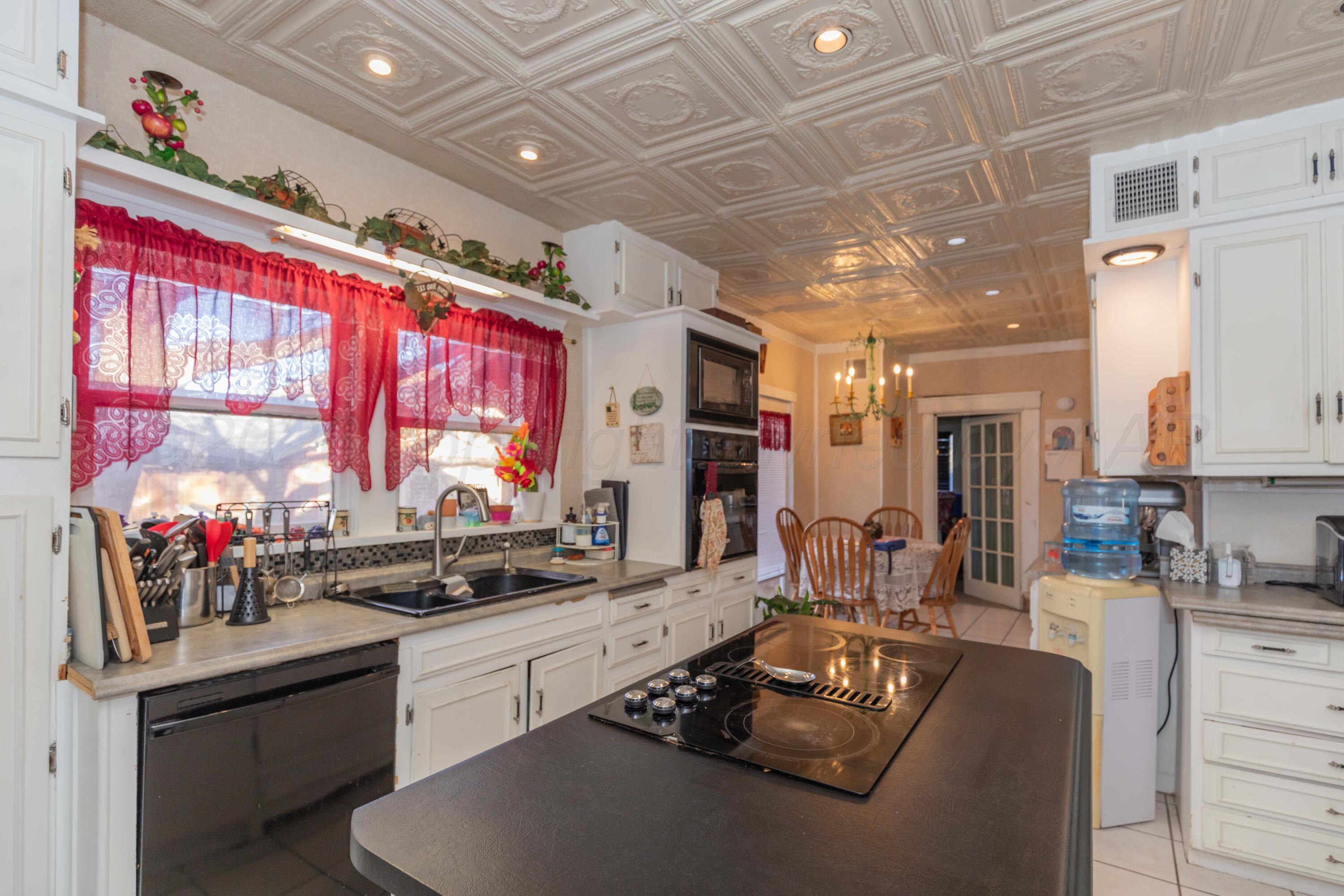 1502 South Monroe Street Amarillo, TX 79101 - Photo 23 of 35 a kitchen with stainless steel appliances kitchen island granite countertop a sink and cabinets