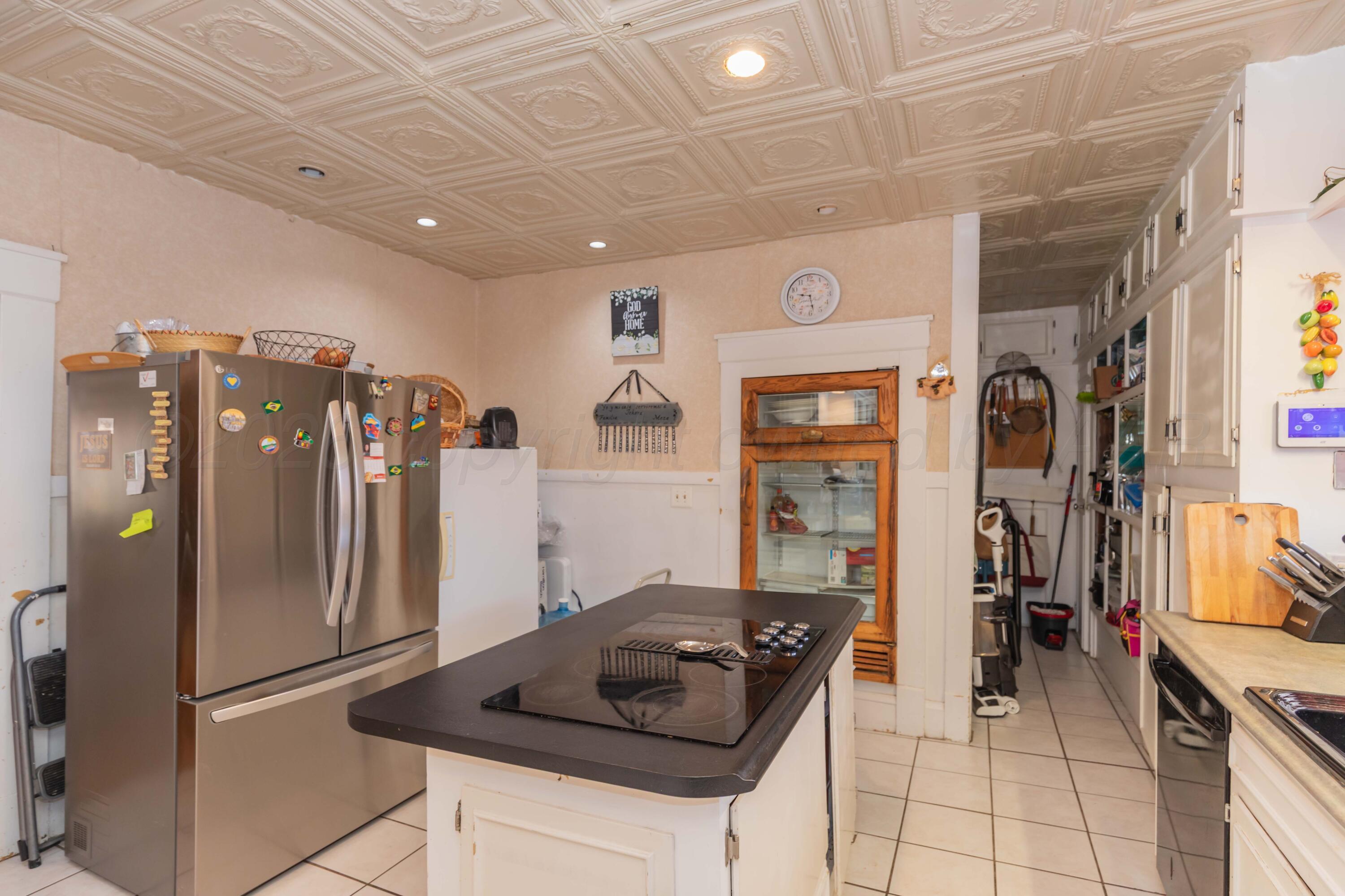 1502 South Monroe Street Amarillo, TX 79101 - Photo 24 of 35 a kitchen with stainless steel appliances granite countertop a refrigerator and a stove
