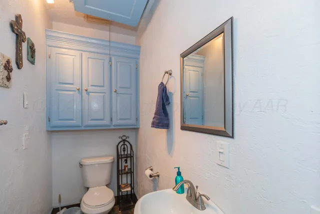 a white toilet sitting next to a bathroom sink