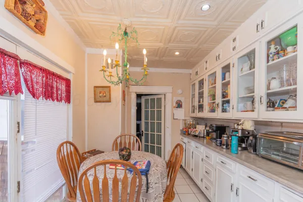 a view of a dining room with furniture and chandelier