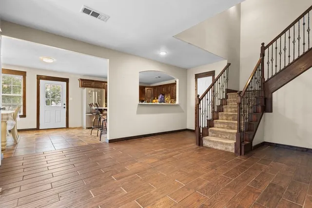 a kitchen with stainless steel appliances granite countertop a refrigerator and a stove top oven