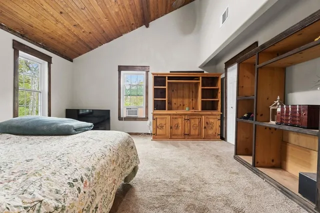 a bedroom with a bed and walk in closet