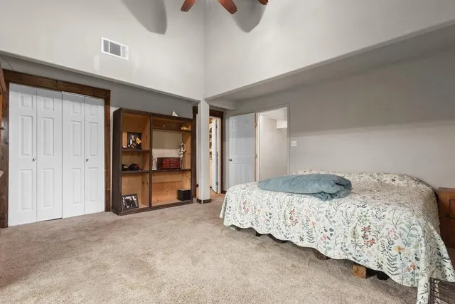 a bathroom with a granite countertop toilet sink and mirror