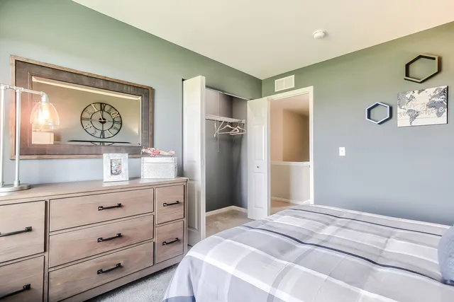 a bedroom with a bed and cabinets