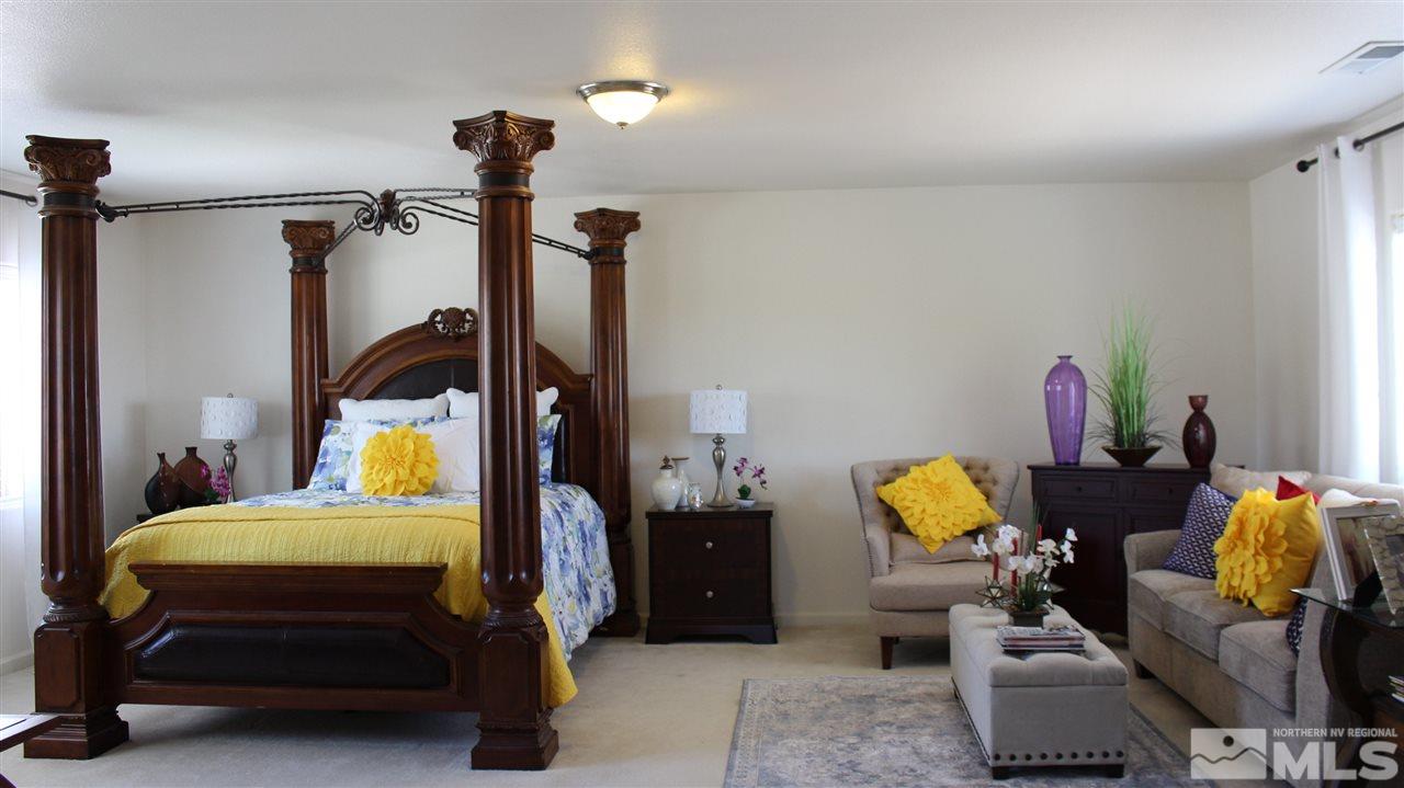 2700 Gulling Court Reno, NV 89503 - Photo 10 of 13 a bedroom with a bed and a chandelier