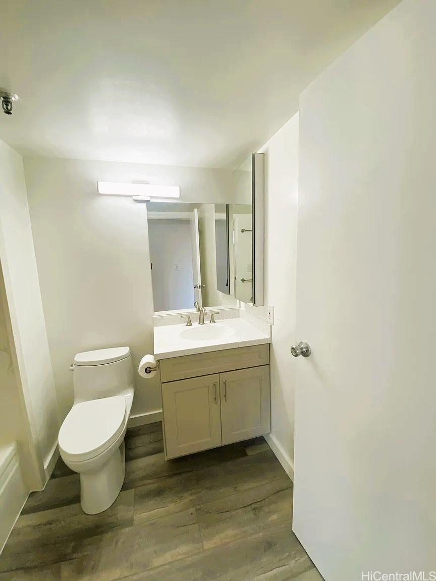 3033 Ala Ilima Street, Unit 1001 Honolulu, HI 96818 - Photo 11 of 12 a bathroom with a toilet sink and mirror
