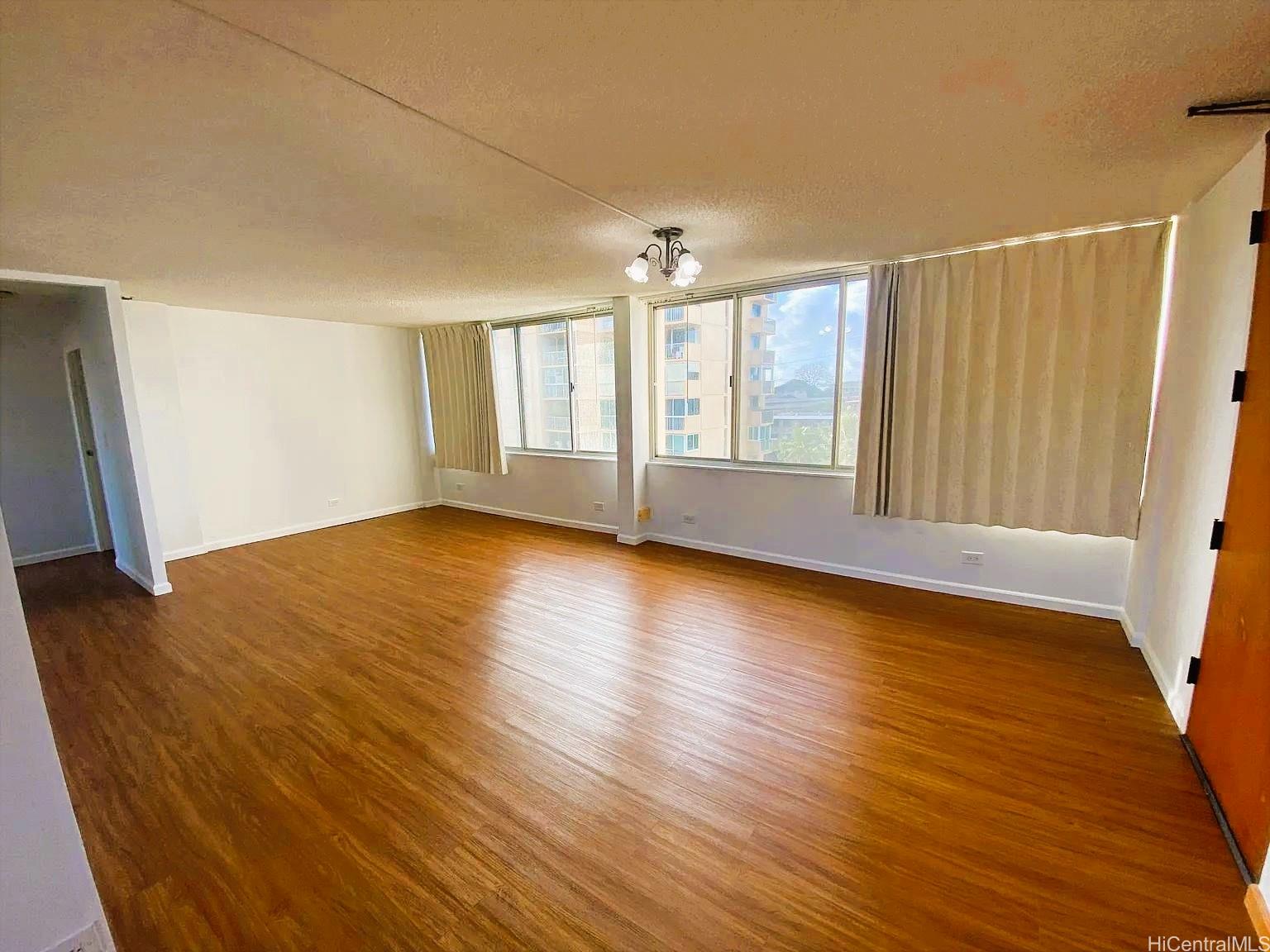 3033 Ala Ilima Street, Unit 1001 Honolulu, HI 96818 - Photo 2 of 12 wooden floor in an empty room with a window