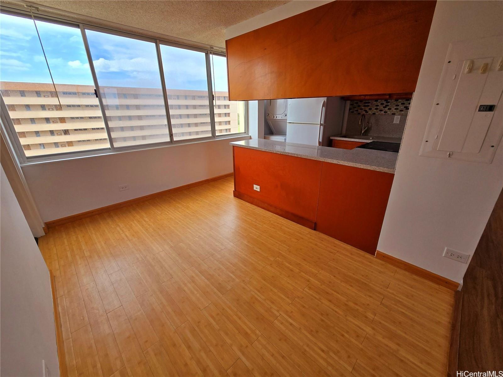 3033 Ala Ilima Street, Unit 1001 Honolulu, HI 96818 - Photo 5 of 12 a view of a kitchen with wooden floor and electronic appliances