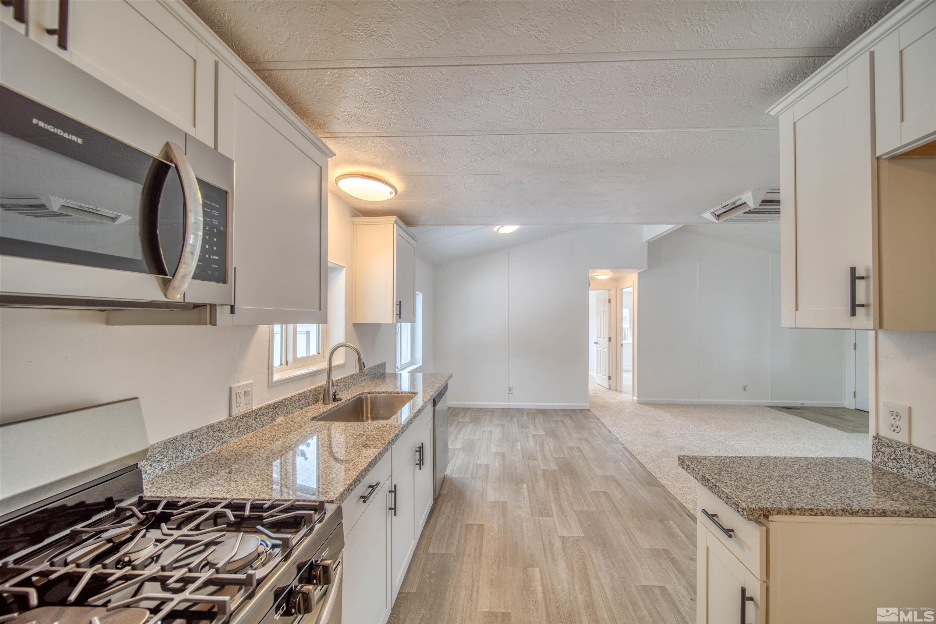 17525 Macaw Lane Reno, NV 89508 - Photo 6 of 22 a kitchen with a sink stove and cabinets