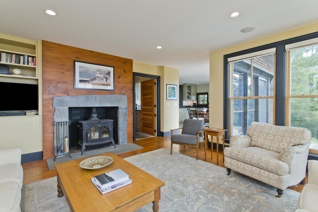 141 Franklin Hill Road Colrain, MA 01340 - Photo 15 of 42 a living room with furniture and a fireplace