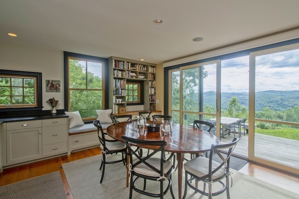 141 Franklin Hill Road Colrain, MA 01340 - Photo 17 of 42 a dining room with furniture a chandelier and wooden floor