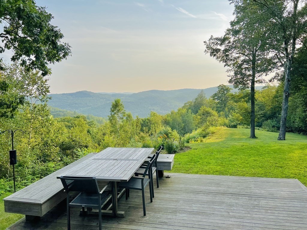 141 Franklin Hill Road Colrain, MA 01340 - Photo 2 of 42 a view of a table and chairs on the deck