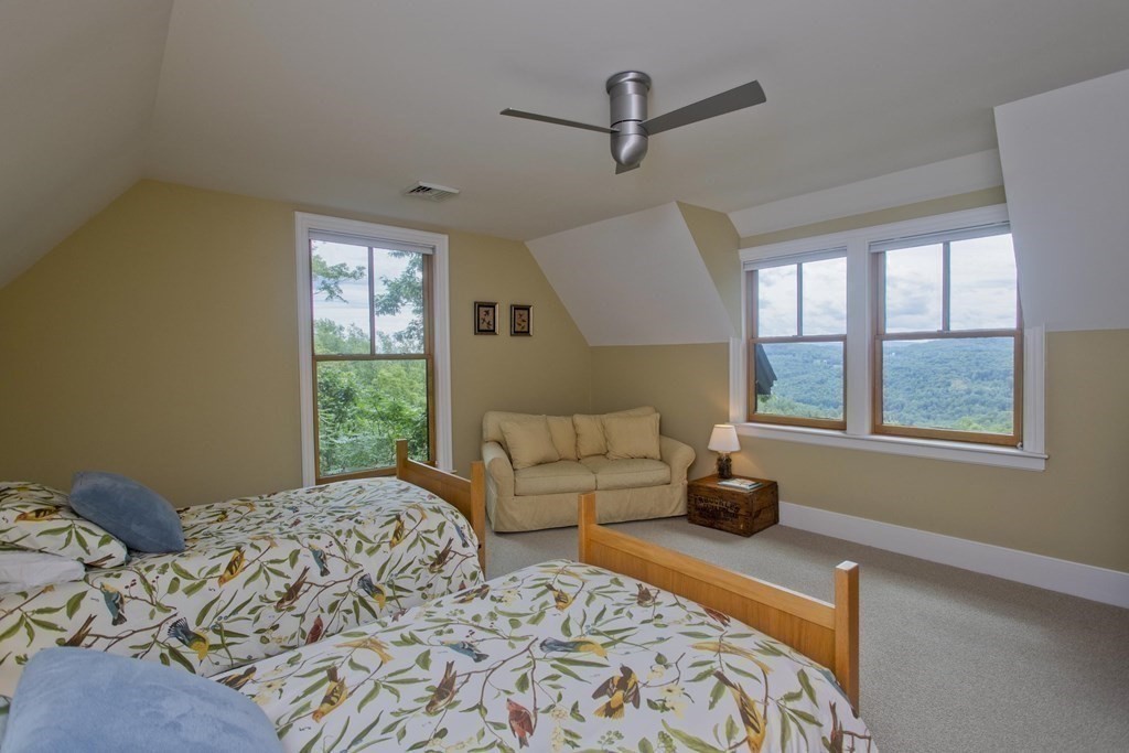 141 Franklin Hill Road Colrain, MA 01340 - Photo 28 of 42 a bedroom with a bed and wooden floor
