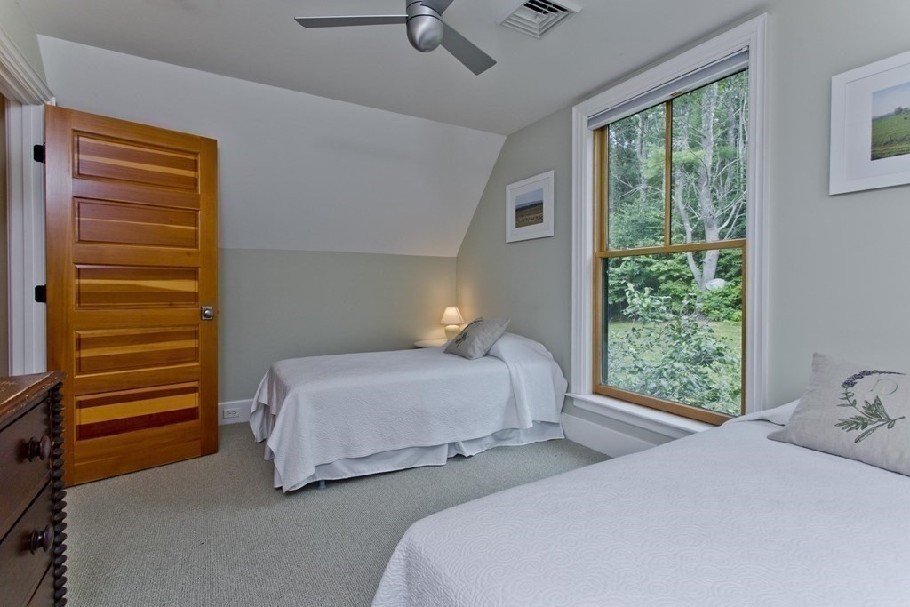 141 Franklin Hill Road Colrain, MA 01340 - Photo 32 of 42 a bedroom with a bed a window and potted plant on the dresser