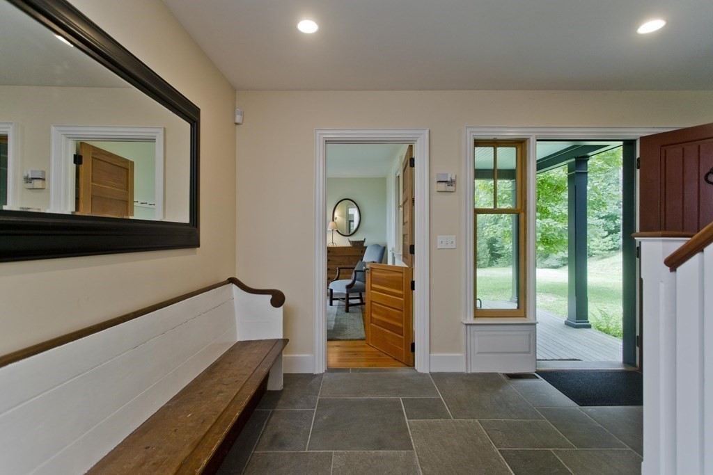 141 Franklin Hill Road Colrain, MA 01340 - Photo 9 of 42 a hallway with a large window and a couch