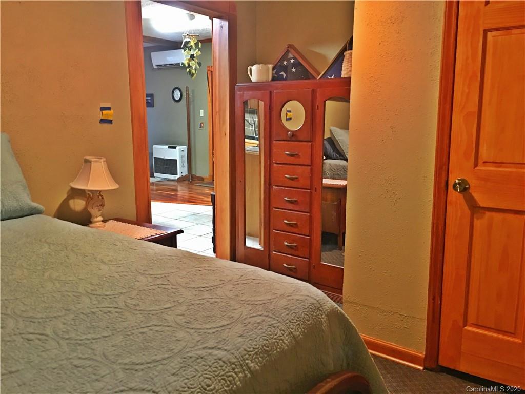 2156 Orchard Road, Unit 1 & 2 Deep Gap, NC 28618 - Photo 23 of 33 a bedroom with a bed and a mirror