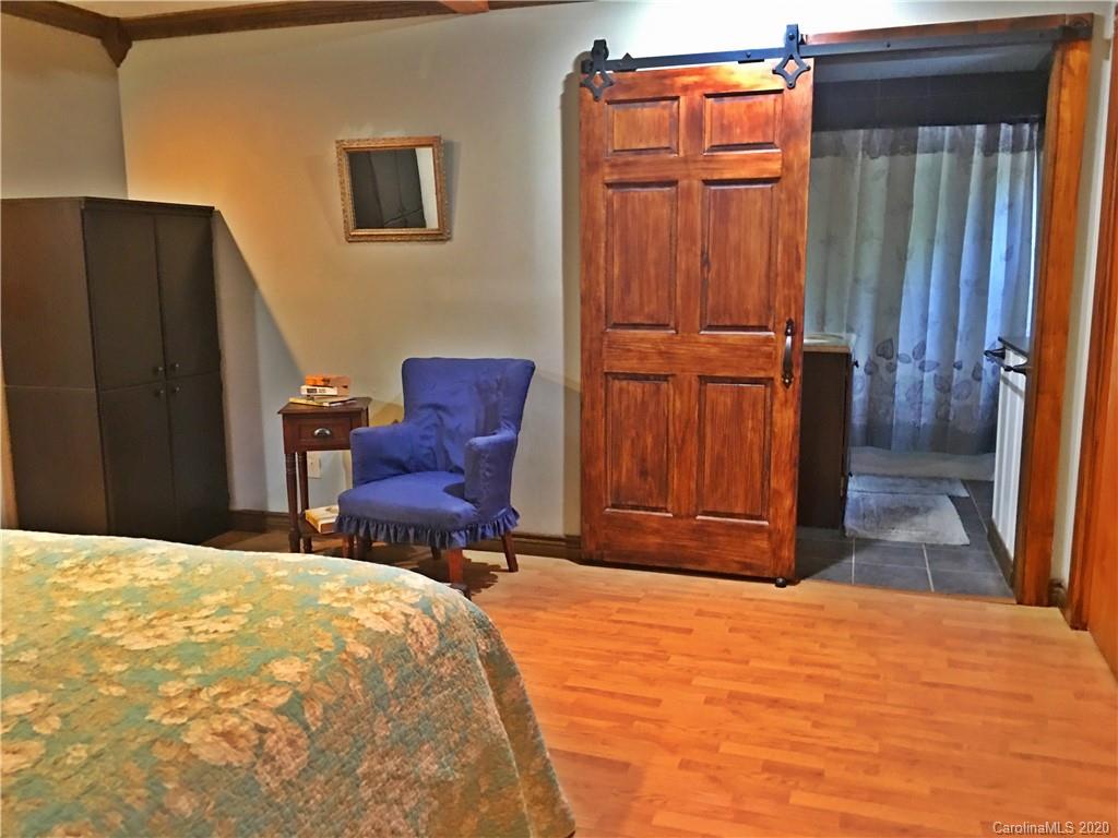 2156 Orchard Road, Unit 1 & 2 Deep Gap, NC 28618 - Photo 25 of 33 a bedroom with a bed and wooden floor