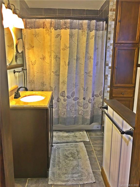 2156 Orchard Road, Unit 1 & 2 Deep Gap, NC 28618 - Photo 26 of 33 a bathroom with a granite countertop shower and a sink