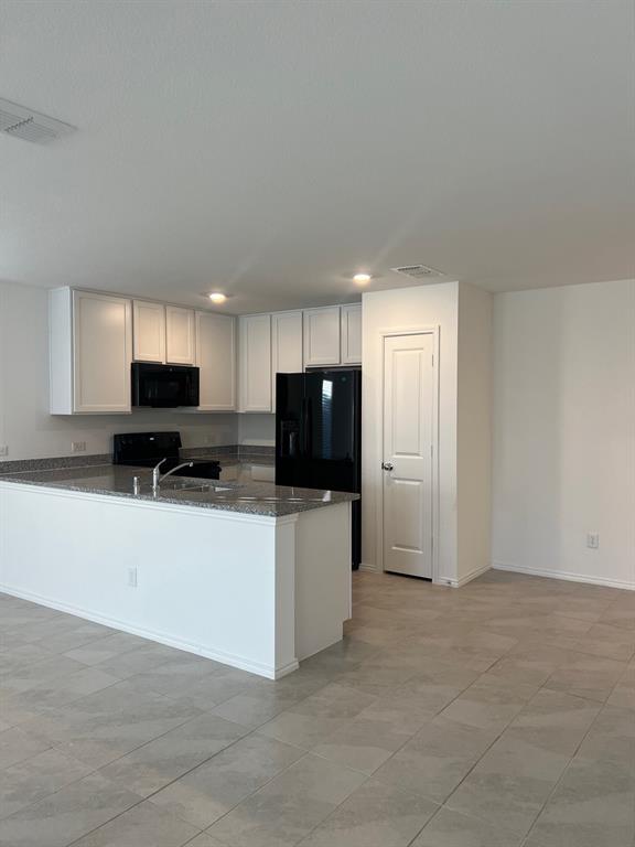 427 Ashbrook Way Princeton, TX 75407 - Photo 2 of 25 a living room with stainless steel appliances kitchen island granite countertop a refrigerator stove top oven a sink and dishwasher