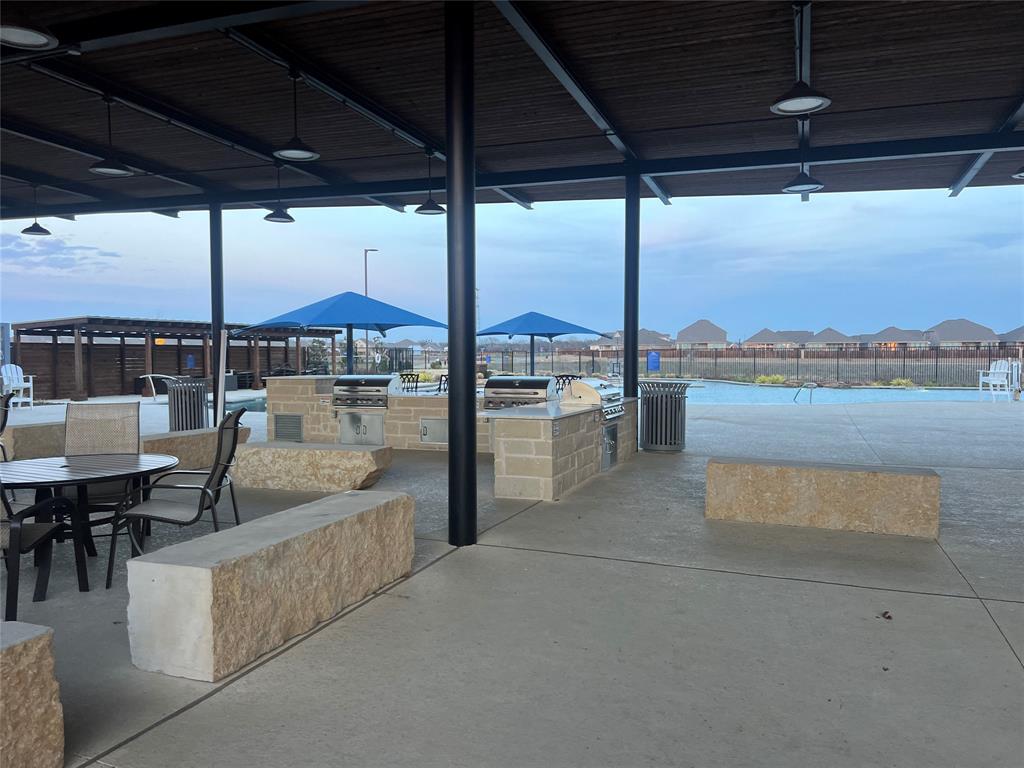 427 Ashbrook Way Princeton, TX 75407 - Photo 24 of 25 a view of a patio with a table and chairs
