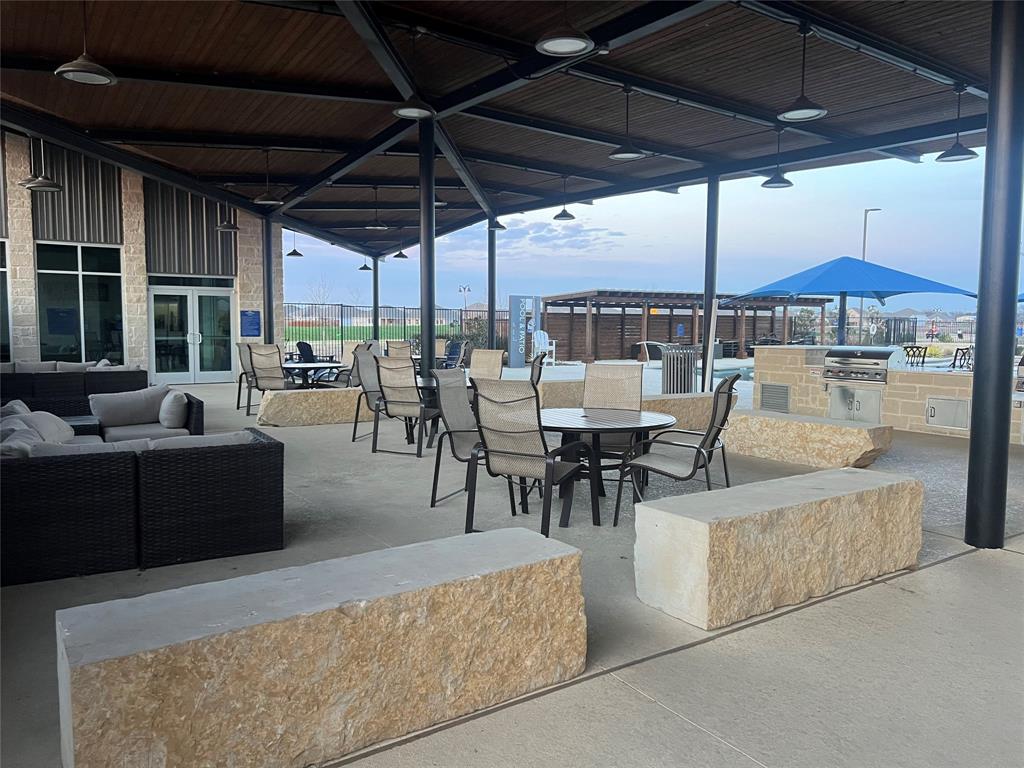 427 Ashbrook Way Princeton, TX 75407 - Photo 25 of 25 a view of a patio with a table and chairs under an umbrella