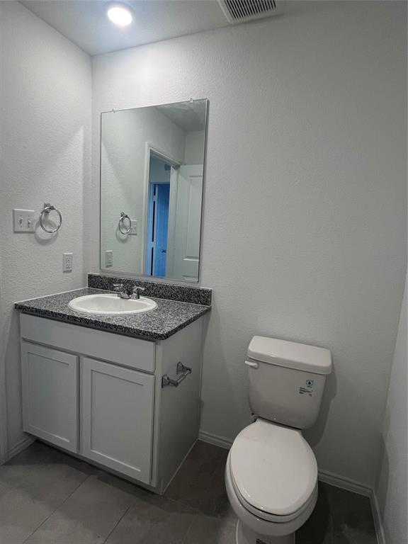 427 Ashbrook Way Princeton, TX 75407 - Photo 8 of 25 a bathroom with a granite countertop toilet a sink and mirror