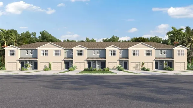 a view of a white house with a yard