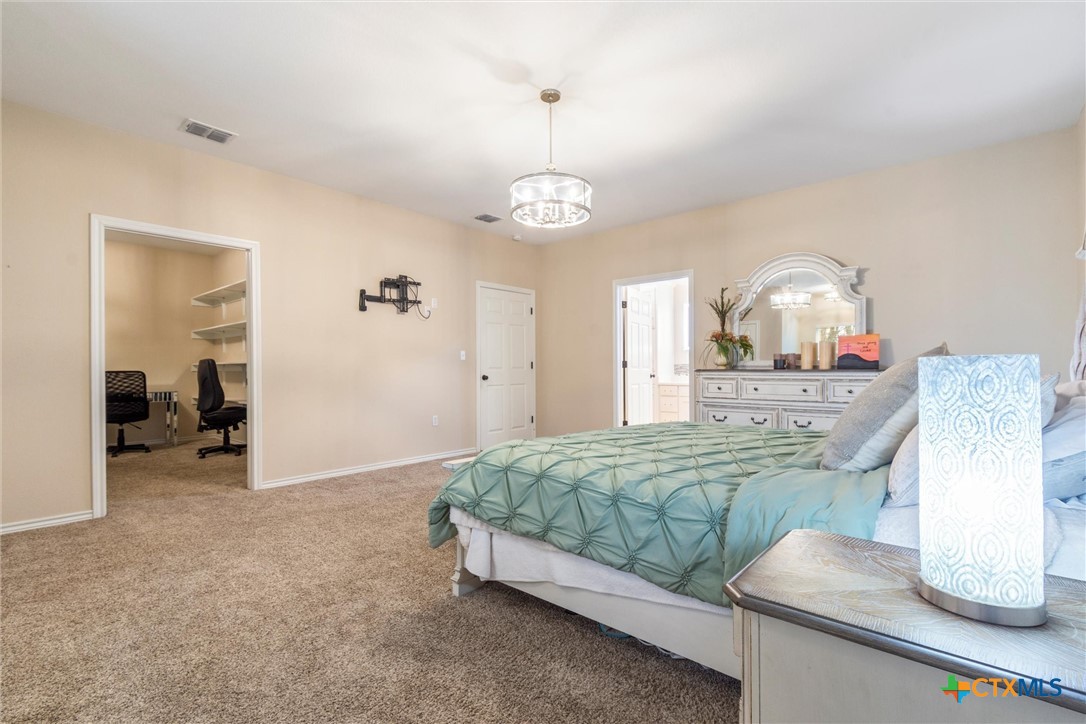 114 Deer Run Moody, TX 76557 - Photo 17 of 40 Master Bedroom featuring carpet floors. See door to left showing guest bedroom, Could be used as a baby's room, craft room, or an office.
