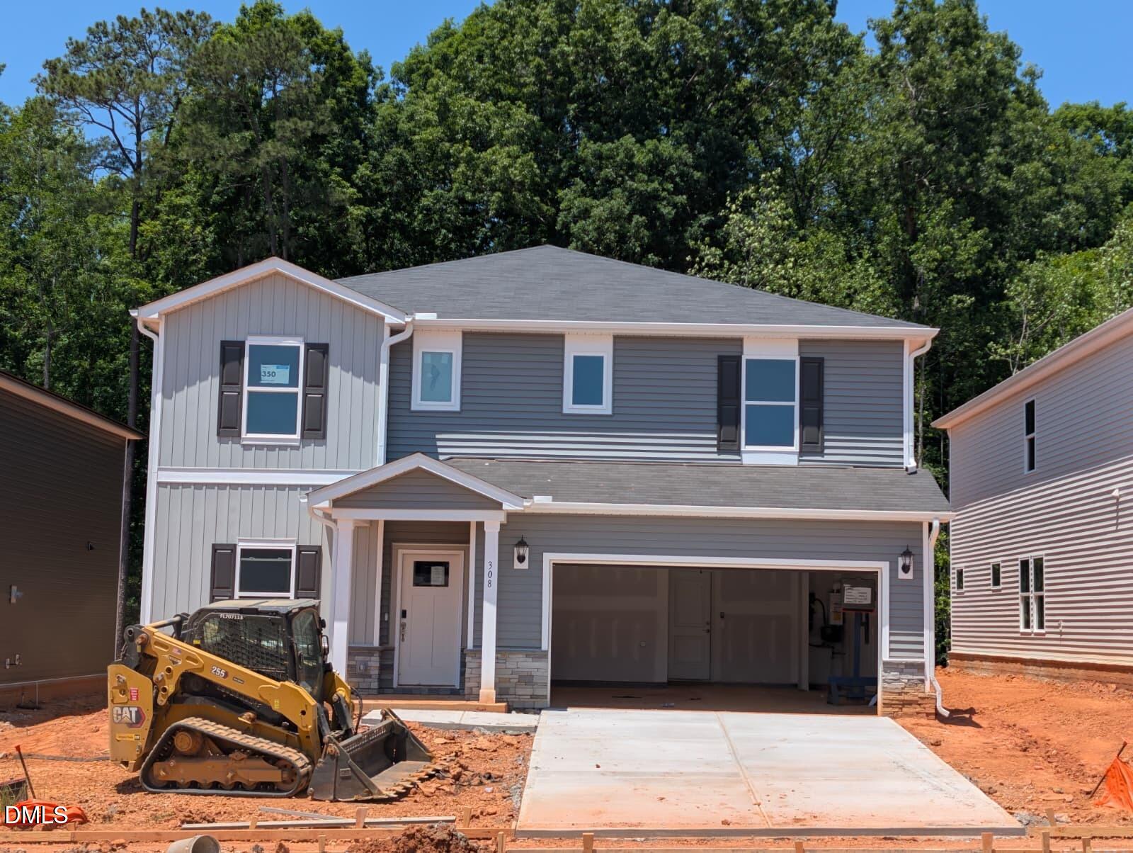 308 Karlov Road Garner, NC 27529 - Photo 2 of 55 a front view of a house with a garden