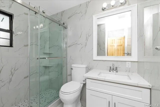 a bathroom with a sink toilet and shower