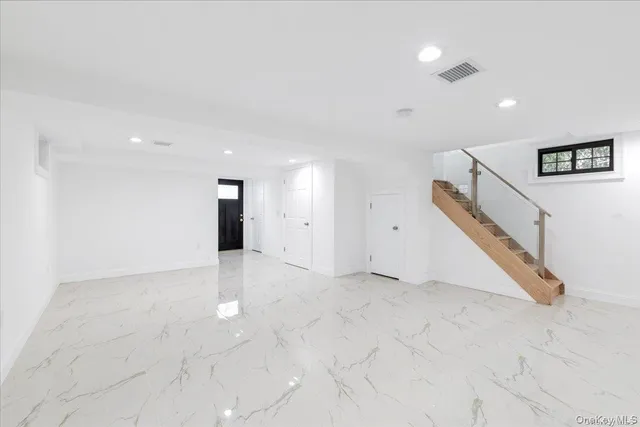 a view of an empty room with stairs