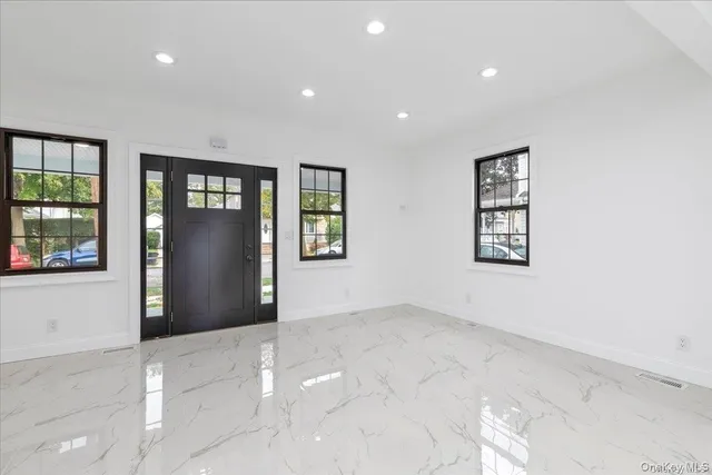 an empty room with windows and entrance