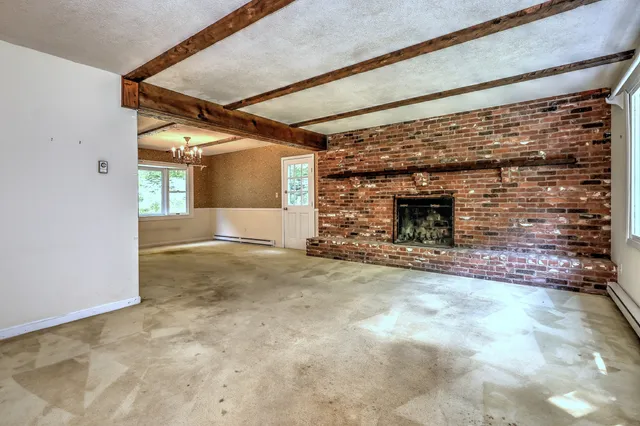 a view of empty room with a fireplace