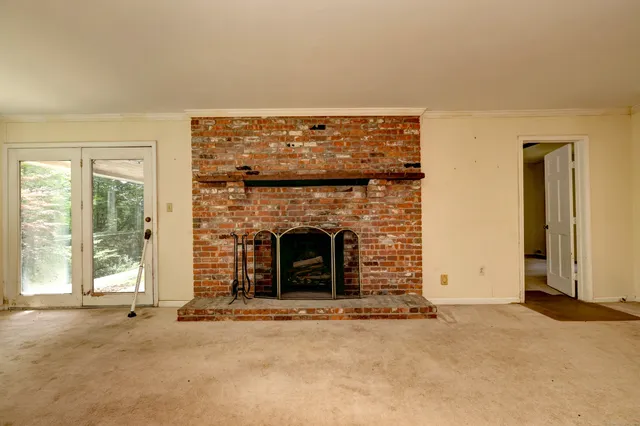 an empty room with a fireplace
