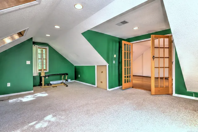a view of an empty room with a fireplace and a window