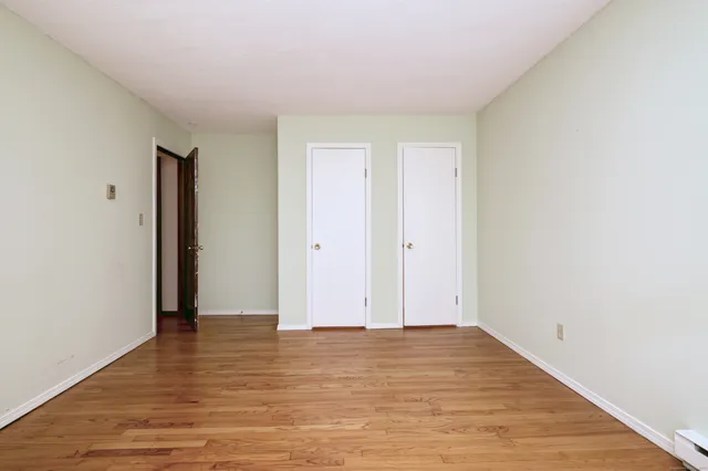 a view of room with wooden floor