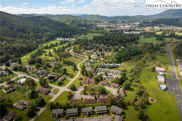 an aerial view of residential houses with outdoor space
