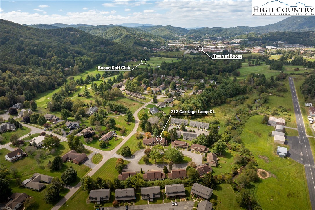 an aerial view of residential houses with outdoor space