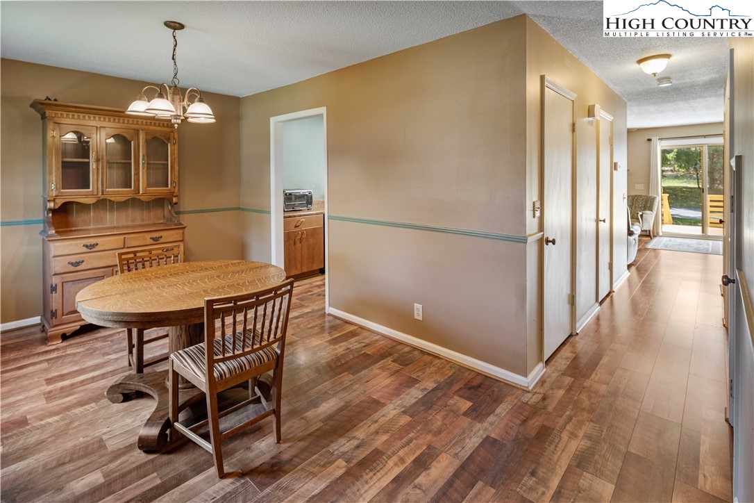 212 Carriage Lamp Court Boone, NC 28607 - Photo 11 of 29 a view of a dining room with furniture window and wooden floor