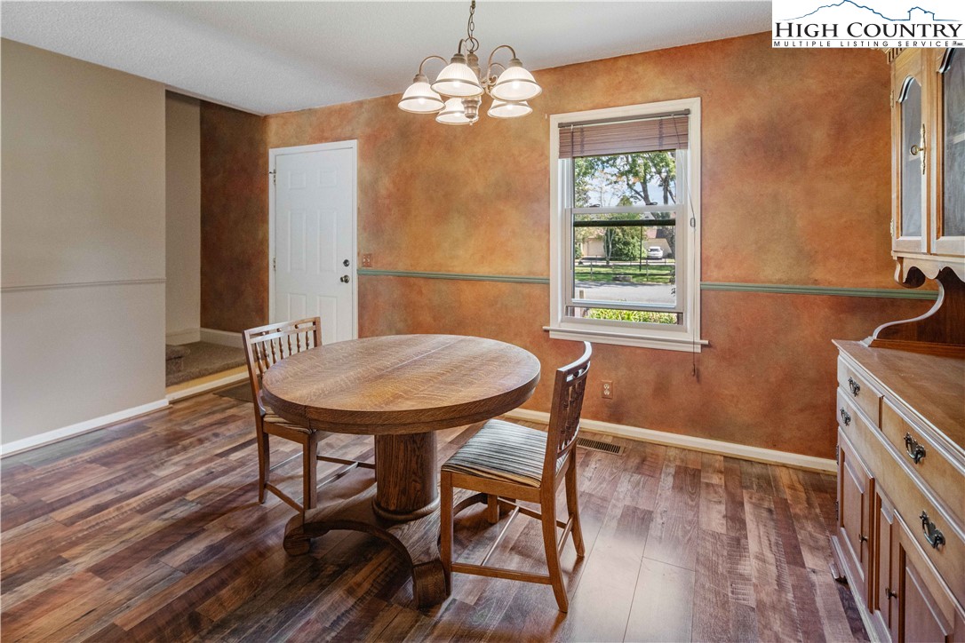 212 Carriage Lamp Court Boone, NC 28607 - Photo 12 of 29 a view of a dining room with furniture window and wooden floor