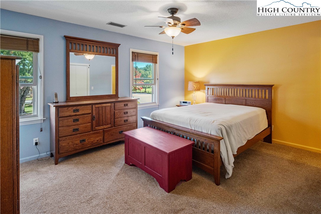 212 Carriage Lamp Court Boone, NC 28607 - Photo 13 of 29 a bedroom with a bed and a chandelier