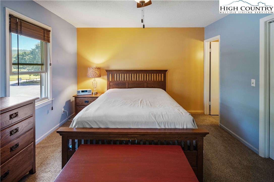 212 Carriage Lamp Court Boone, NC 28607 - Photo 14 of 29 a bed sitting in a bedroom next to a window