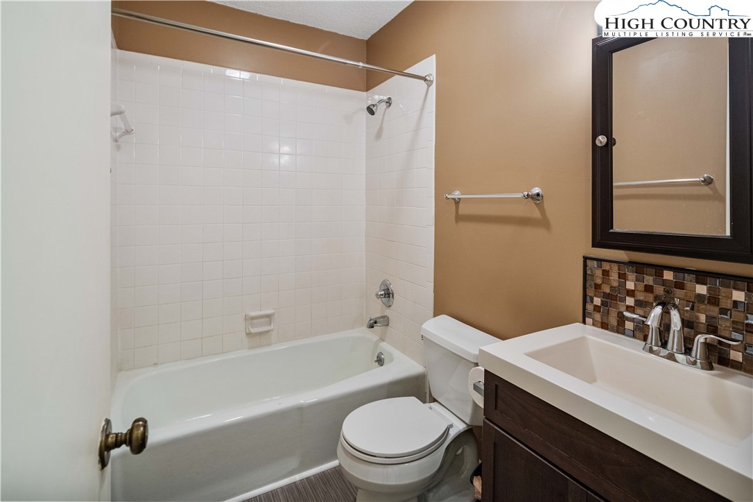 212 Carriage Lamp Court Boone, NC 28607 - Photo 19 of 29 a bathroom with a sink a toilet and shower