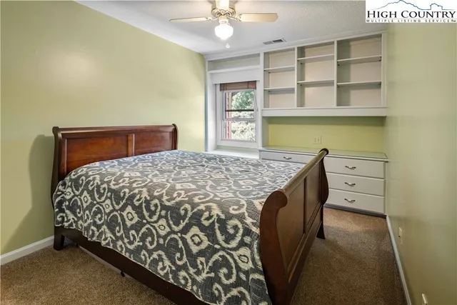 a bed sitting in a kitchen next to a window