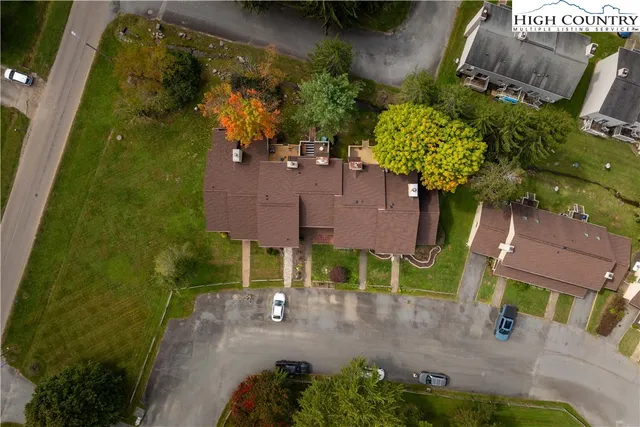 an aerial view of a house with a yard basket ball court and outdoor seating