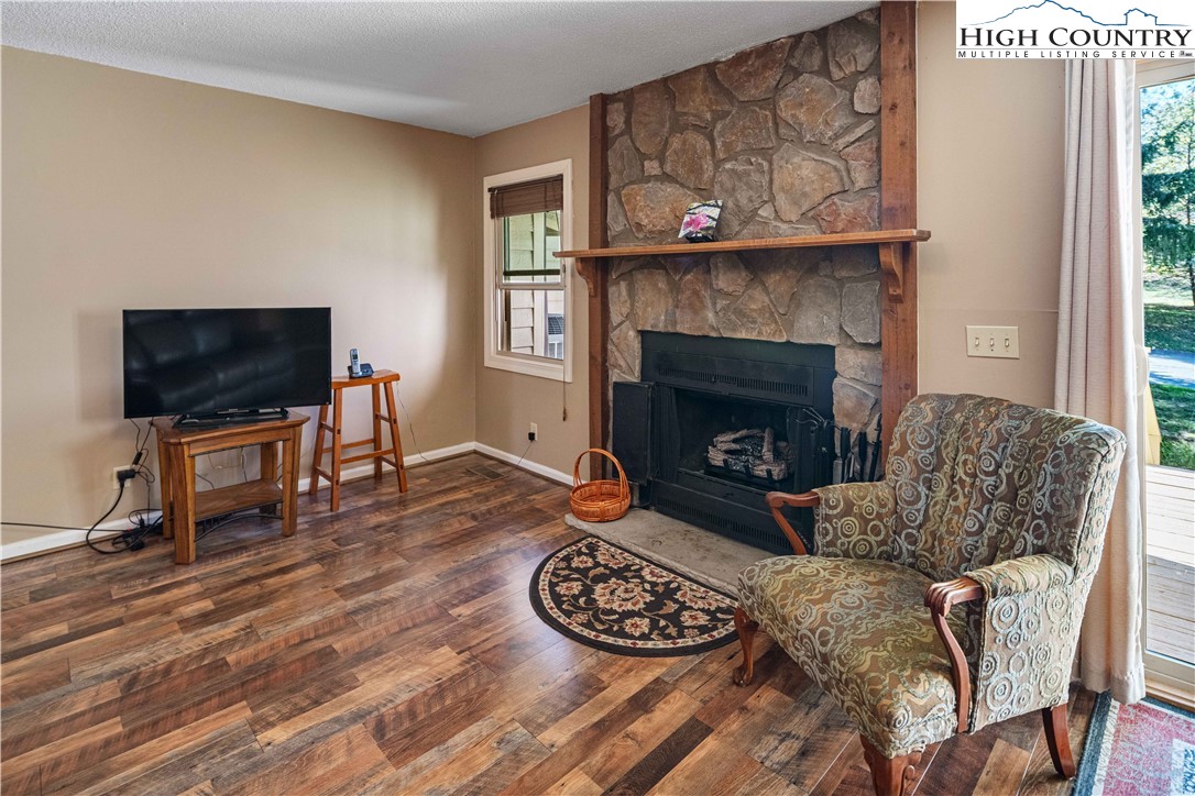 212 Carriage Lamp Court Boone, NC 28607 - Photo 8 of 29 a living room with furniture a flat screen tv and a fireplace